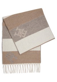 Écharpe tissée aux tons terreux de brun, beige et crème, avec un motif chevrons et des bords à franges ; détails du logo en gris clair.