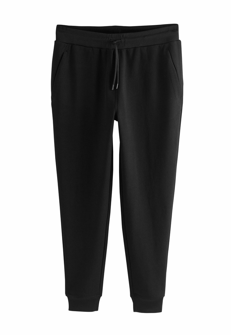 Zwarte joggingsbroek van zacht materiaal met een trekkoord in de taille, zijzakken en aansluitende boorden bij de enkels. Gladde textuur, geen patronen.