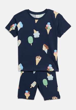 Ensemble pour enfants bleu marine avec chemise à manches courtes et short, motif coloré de cornets de glace et sucettes souriants.