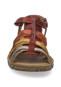 Multi-colored leather sandal featuring red, orange, and silver straps. Open toe design with textured sole and adjustable buckle.