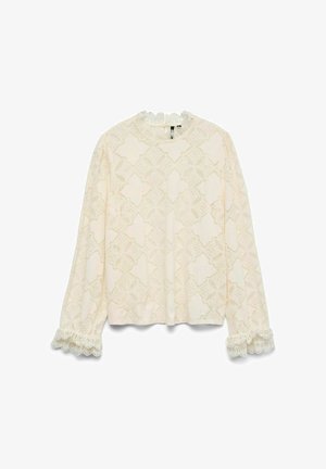 Haut à manches longues en dentelle crème avec des motifs floraux élaborés, décolleté en forme de vagues et poignets. Texture douce, coupe décontractée, bordure en dentelle détaillée.