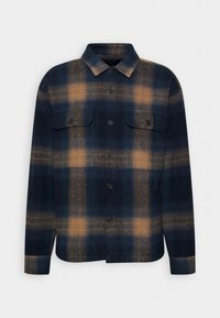 Geruit overhemd in marineblauw en oranje tinten, gemaakt van zachte stof. Heeft twee borstzakken, knopen en een kraag.