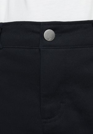 Pantaloni din denim negru cu o textură netedă, prezentând un nasture metalic argintiu și un detaliu de buzunar mic în față.