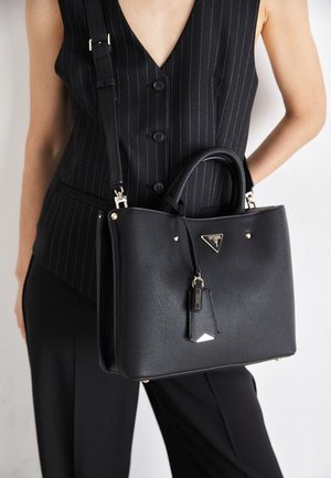 Black textured leather handbag with dual handles, adjustable strap, triangular logo, and metal hardware accents.