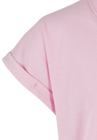 Lys rosa T-skjorte med korte rullede ermer, myk bomullstekstur, rund hals-design og synlige sømdetaljer på erme kanten.