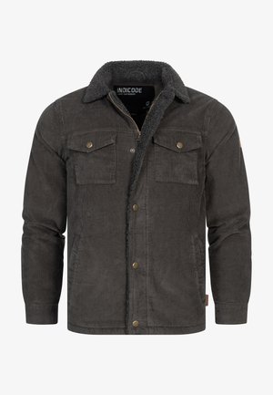 Corduroy jacket in dark gray with a sherpa collar, two chest pockets, and brass hardware details. Features a zip closure and ribbed cuffs.