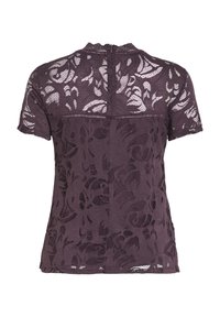 Blouse noire en dentelle à manches courtes avec motifs floraux, dos supérieur semi-transparent, et fermeture éclair au dos.