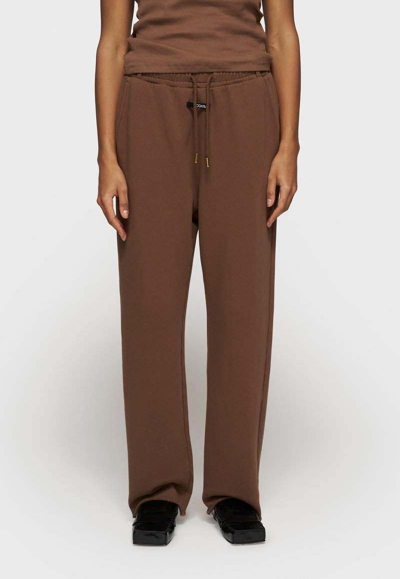 Bruine sweatpants van katoenmix met een relaxte pasvorm, elastische tailleband en koord. Rechte voorkant zonder zichtbare patronen of accenten.