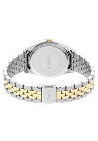Montre en acier inoxydable argent et or avec un boîtier rond, un bracelet en maillons et un cadran lisse et minimaliste arborant le nom de la marque "TIMEX."