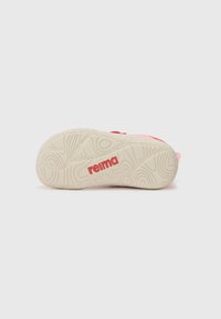 Pink sandal with a textured beige sole, featuring a rubber bottom with a patterned grip and a red "reima" logo on the side.