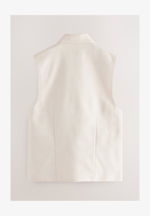 Mouwloos getailleerd vest in lichtbeige stof. Voorzien van een puntige kraag en een subtiel getextureerd patroon. Strakke lijnen en een gestructureerd ontwerp.