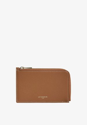 Brown leather wallet with a textured finish, featuring a zip closure and cream stitching. Subtle embossed brand logo on the front.
