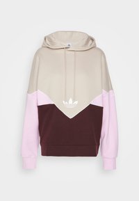 Hoodie med beige och vinröda paneler, med rosa detaljer. Vit logotyp i mitten och snören på huvan. Mjuk tyg.