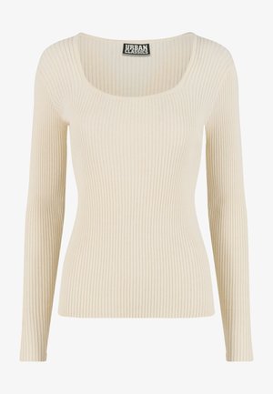 Ribbad långärmad topp i off-white med bred rund halsringning och figurnära silhuett. Tillverkad av mjukt och stretchigt material.