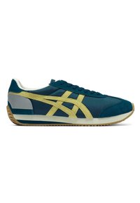 Blue and yellow athletic shoes featuring a suede and fabric upper, a rubber outsole, and a distinct asymmetrical design.