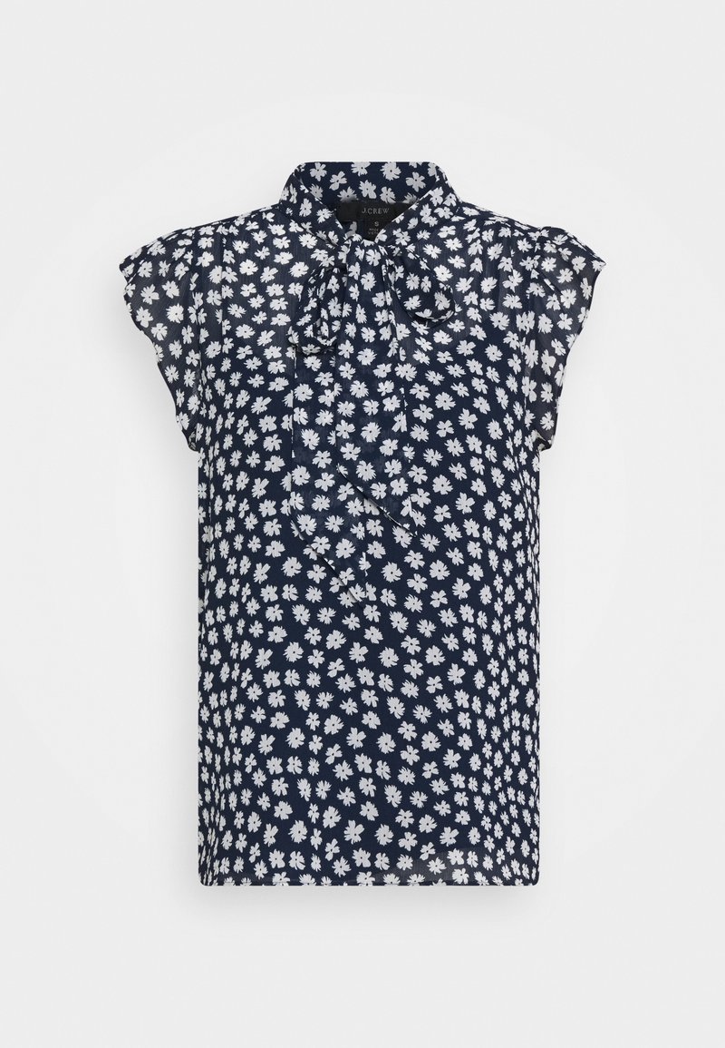 Blouse sans manches bleu marine avec motif floral blanc et un nœud noué au col.