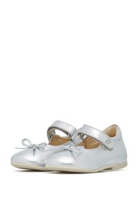 Zapatos Mary Jane de cuero plateado con una textura suave, punta redonda y un lazo decorativo. Cuentan con una correa de Velcro para el cierre. Suela de color claro.