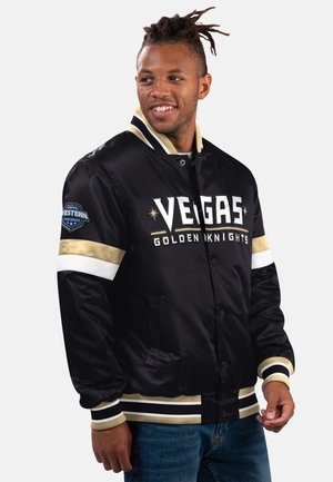 Black satin bomber jacket featuring "VEGAS GOLDEN KNIGHTS" in white lettering, gold and white stripes, and NHL Western Conference logo on sleeve.