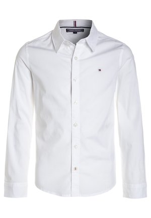 Hvid langærmet skjorte med krave og lille Tommy Hilfiger-logo på venstre bryst.