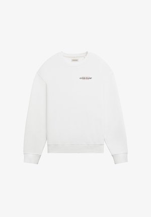 White sweatshirt with round neckline, long sleeves, and ribbed cuffs. Features a small black "GUESS JEANS" logo on the chest. Smooth texture.