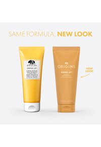 Twee gele tubes van Origins Drink Up hydraterend masker, één met een wit etiket en zwarte tekst, de ander geheel geel met een reliëflogo.