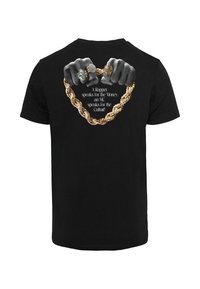 Black t-shirt featuring a graphic of two hands gripping a gold chain, adorned with rings, overlaid with white text.