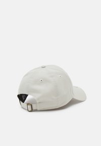 Light gray baseball cap with a curved brim, stitched detailing, rear adjustable strap with metal clasp, and ventilation eyelets.