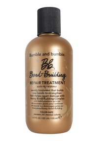 Bumble and Bumble Bond-Building Repair Treatment i en metallisk guldflaska med ett svart ribbat lock. Innehåller 125 ml produkt; färgsäker.