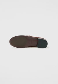 Single brown leather shoe viewed from the sole, showing size 37 and brand name embossed on the heel section.