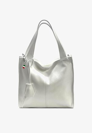 White leather tote bag with two handles, smooth texture, curved top, a side pocket, and a hanging Italian flag charm. Zipper closure.