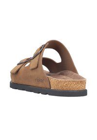 Sandale en cuir brun avec un dos ouvert, des lanières ajustables et une semelle intermédiaire en liège. Dispose d'une semelle intérieure texturée et d'une semelle extérieure en caoutchouc noir.