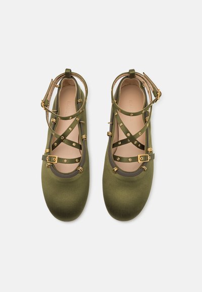 Olive green ballet flats with strap detailing, gold hardware accents, smooth texture, and a round toe design.