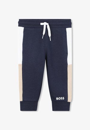 Navy blauwe joggers met witte en beige zijpanelen, voorzien van een trekkoord in de taille en een logo op het onderbeen. Gemaakt van een katoenmix.