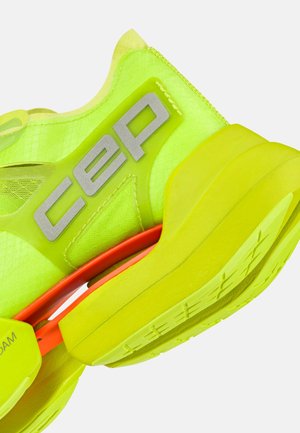 Bright neon yellow athletic shoe with thick sole, reflective "CEP" logo on side, and orange support detail above the sole.