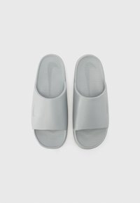 Gray slide sandals with a smooth textured upper, open back, and ridged sole. Features a subtle logo on the strap.