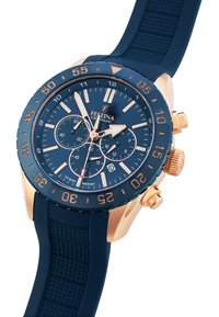 Reloj de cerámica navy con bisel bicolor en oro rosa, diales de cronógrafo azules, correa de goma texturizada y marcadores de hora luminosos.