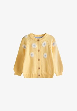 Cardigan giallo lavorato a maglia con bottoni marroni, maniche lunghe, polsini e orlo a coste, decorato con fiori ricamati bianchi e blu.
