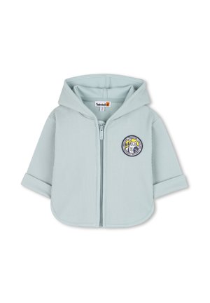 Lichtblauwe zip-up hoodie met ribbeltextuur, korte mouwen en een ronde patch. Ontworpen voor kinderen met een relaxte pasvorm.