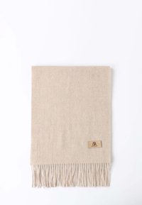 Sciarpa di lana beige con bordi frangiati e una piccola etichetta marrone nell'angolo inferiore. La texture sembra morbida e liscia.