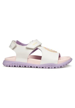 Sandalia infantil blanca y lavanda con punta abierta, suela acolchada, correas ajustables y una colorida decoración circular de cupcake en la parte superior.