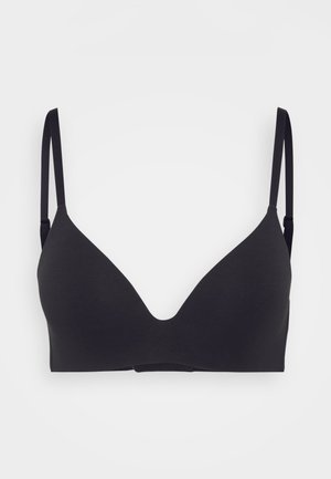 Black seamless bra with a deep V-neck design, adjustable straps, soft fabric, and no visible hardware or embellishments.