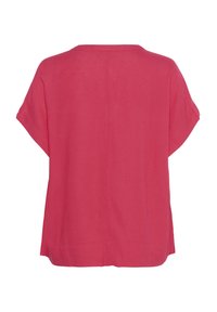 Haut ample à manches courtes en lin rose. Présente un col rond simple et une coupe droite, avec un ourlet arrière plus long.