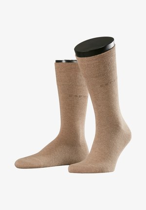 Beige Baumwollsocken mit ribbeliger Textur und glatter Oberfläche. Mit einem Logodetail entlang des oberen Randes. Knöchellanges Design.