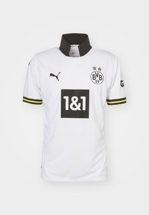 Valge spordijadpüks musta krae ja lühikeste varrukatega, millel on kollased aktsendid, Puma logo ja suur must kast, millel on "1&1" logo.