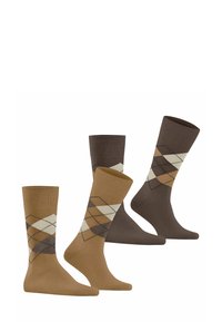 Quatre paires de chaussettes présentant un motif argyle dans des nuances de brun et de beige. Les matériaux semblent doux, avec des poignets côtelés et des hauteurs variées.