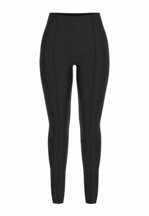 Leggings neri a vita alta e taglio skinny con cuciture verticali visibili che scorrono lungo la parte anteriore di entrambe le gambe.