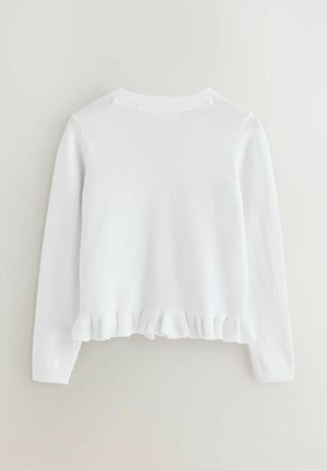 Valkoinen neulepaita, jossa on pitkät hihat, pyöreä pääntie ja röyhelöhelma. Pehmeä rakenne ja tasaista ompelemista koko vaatteessa.