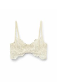 Krajkový bralet v odstínu smetanové s vlnkovanými okraji a nastavovacími ramínky, zdobený květinovými vzory a jemnou texturou.