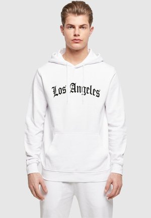 Hvit hettegenser laget av bomullsblanding med frontlomme og svart "Los Angeles" tekst i kursiv. Glatt tekstur med ribbede mansjetter.