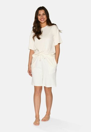 Light beige short-sleeve top and matching shorts made of ribbed fabric, featuring an elastic waist, drawstring, and side pockets.